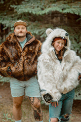 Woman wearing the wildcoat polar bear bomber coat next to a man wearing the wildcoat grizzly bear bomber coat