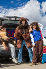 group of buffalo bills fans wearing buffalo bison hoods and coats at a tailgate
