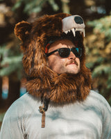 The wildcoat grizzly bearaclava v6, worn fastened with the collar extender connected over a ski helmet