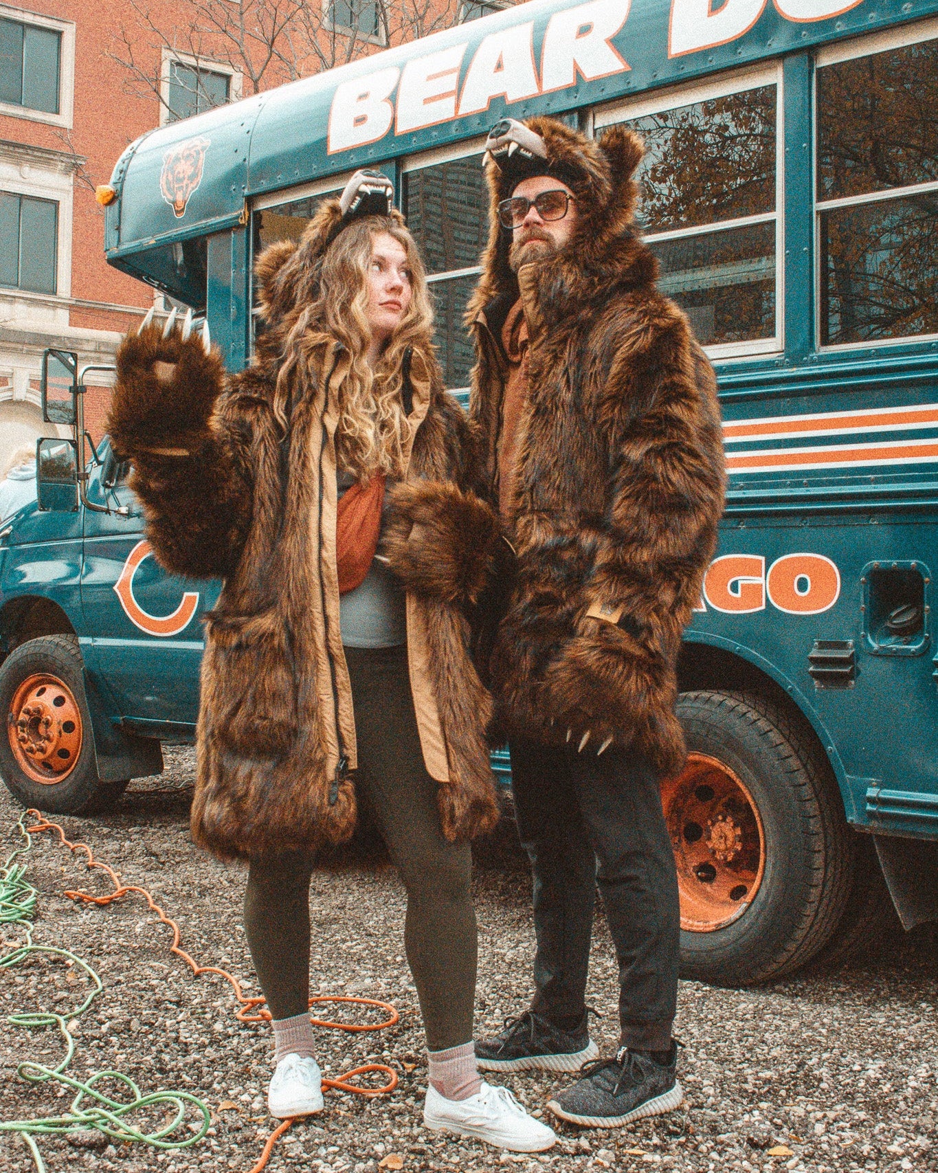 Two people wearing Wildcoat Grizzly Bear Parkas at a bears game