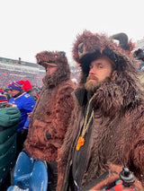two men at a buffalo bills game wearing faux fur buffalo bison parkas