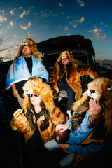 Five detroit lions fans wearing wildcoat lion parkas at a tailgate celebrating