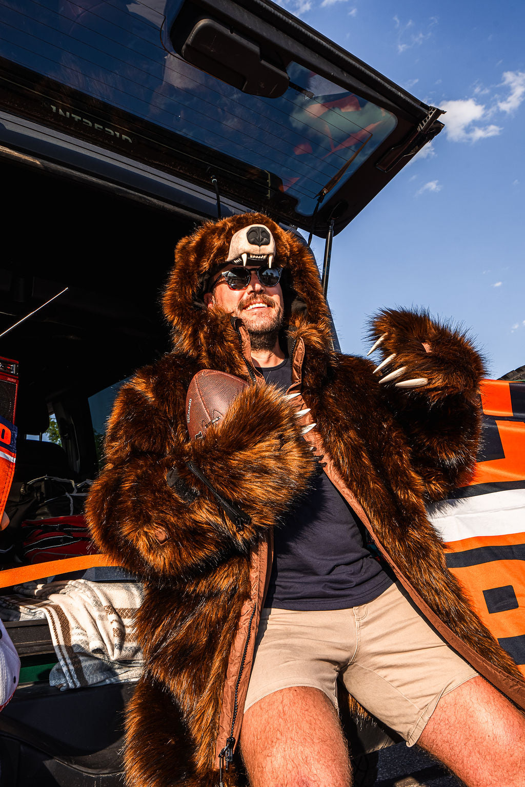 Man wearing a wildcoat v6 grizzly bear coat at a chicago bears tailgate