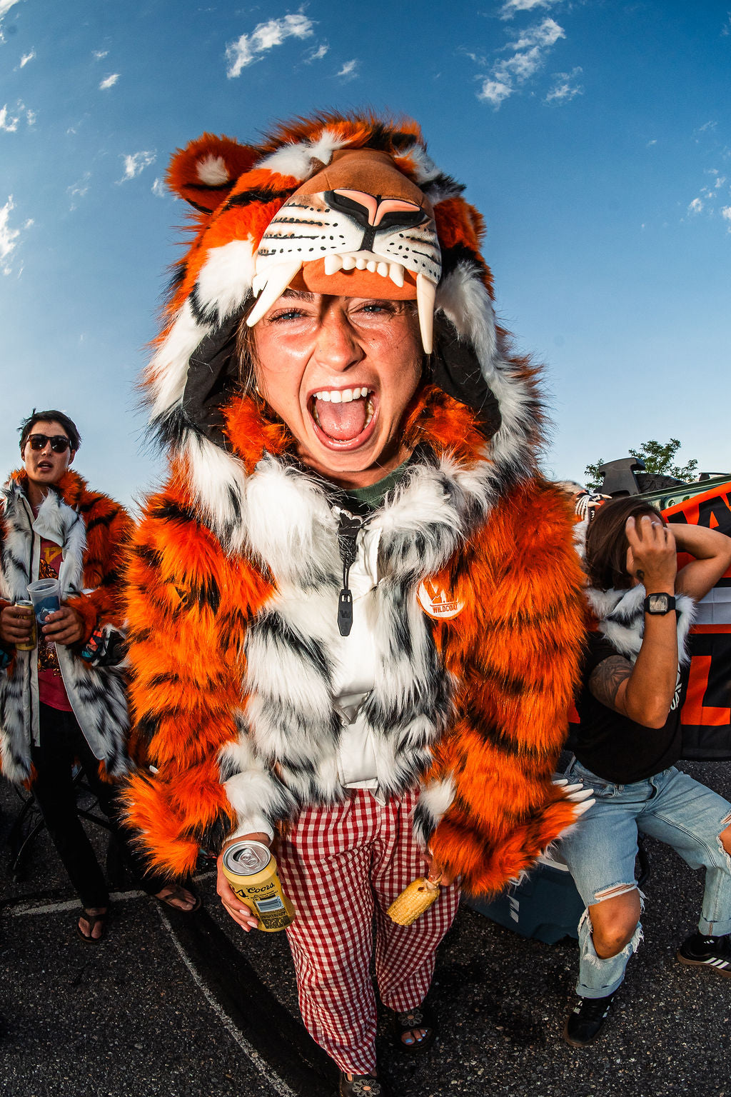 Woman Cincinnati Bengals fan wearing the wildcoat orange bengal tiger bomber at a tailgate