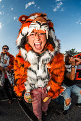 Woman Cincinnati Bengals fan wearing the wildcoat orange bengal tiger bomber at a tailgate