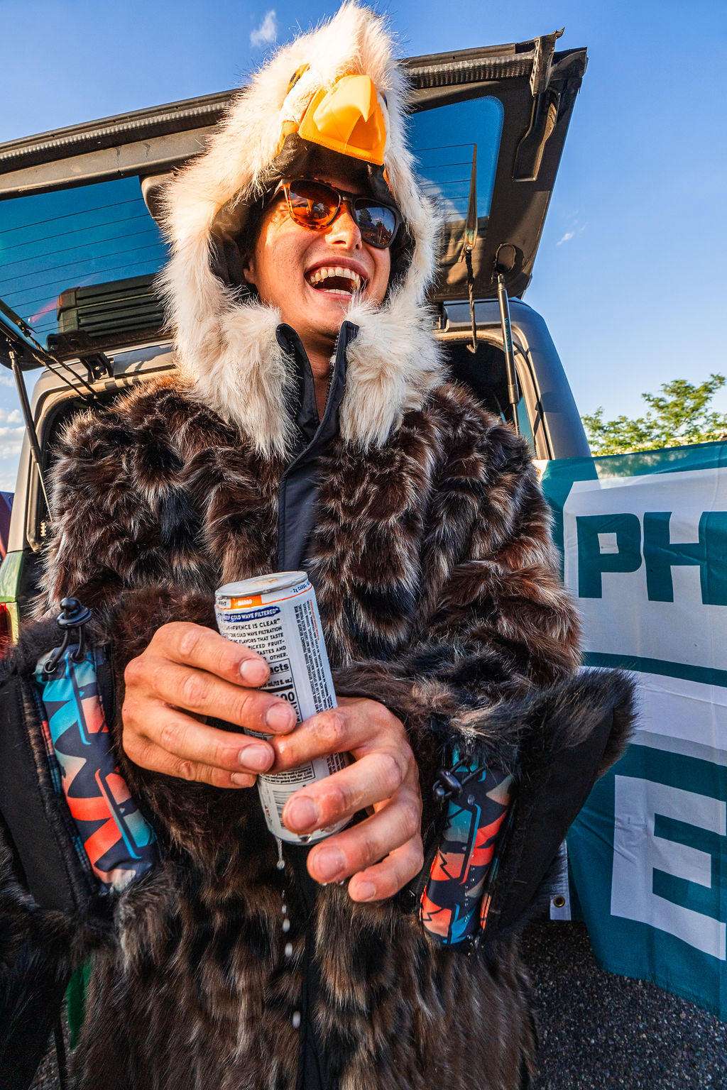 the wildcoat eagle parka v6 shown on a handsome fan at the phildalphia eagles tailgate in the parking lot