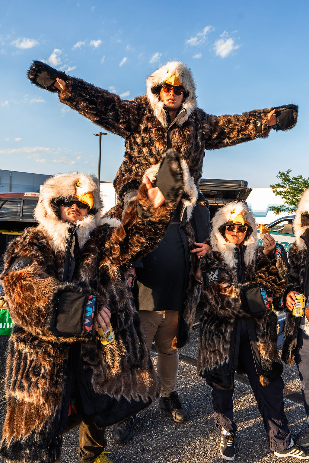 group of 4 eagles fans at a tailgate in philly wearing the wildcoat eagle v6