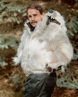 The Wildcoat Polar Bear Bomber on male model with hands in pockets, bear hood off the shoulder