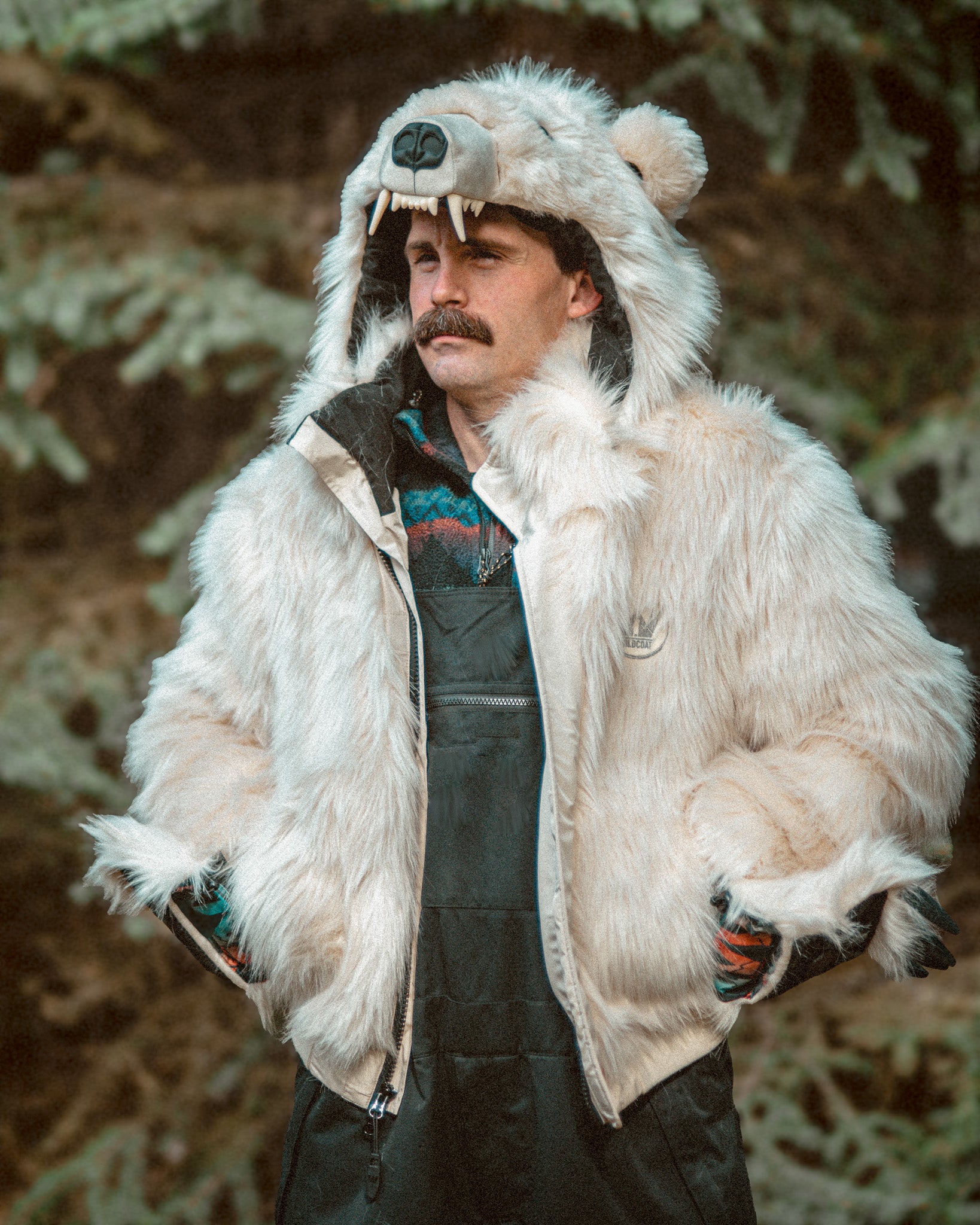 Wildcoat Polar Bear Bomber Coat with male model, hands in pockets with clawed mittens flipped back