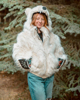 Wildcoat Polar Bear Bomber Coat with female model, hands in pockets with clawed mittens flipped back