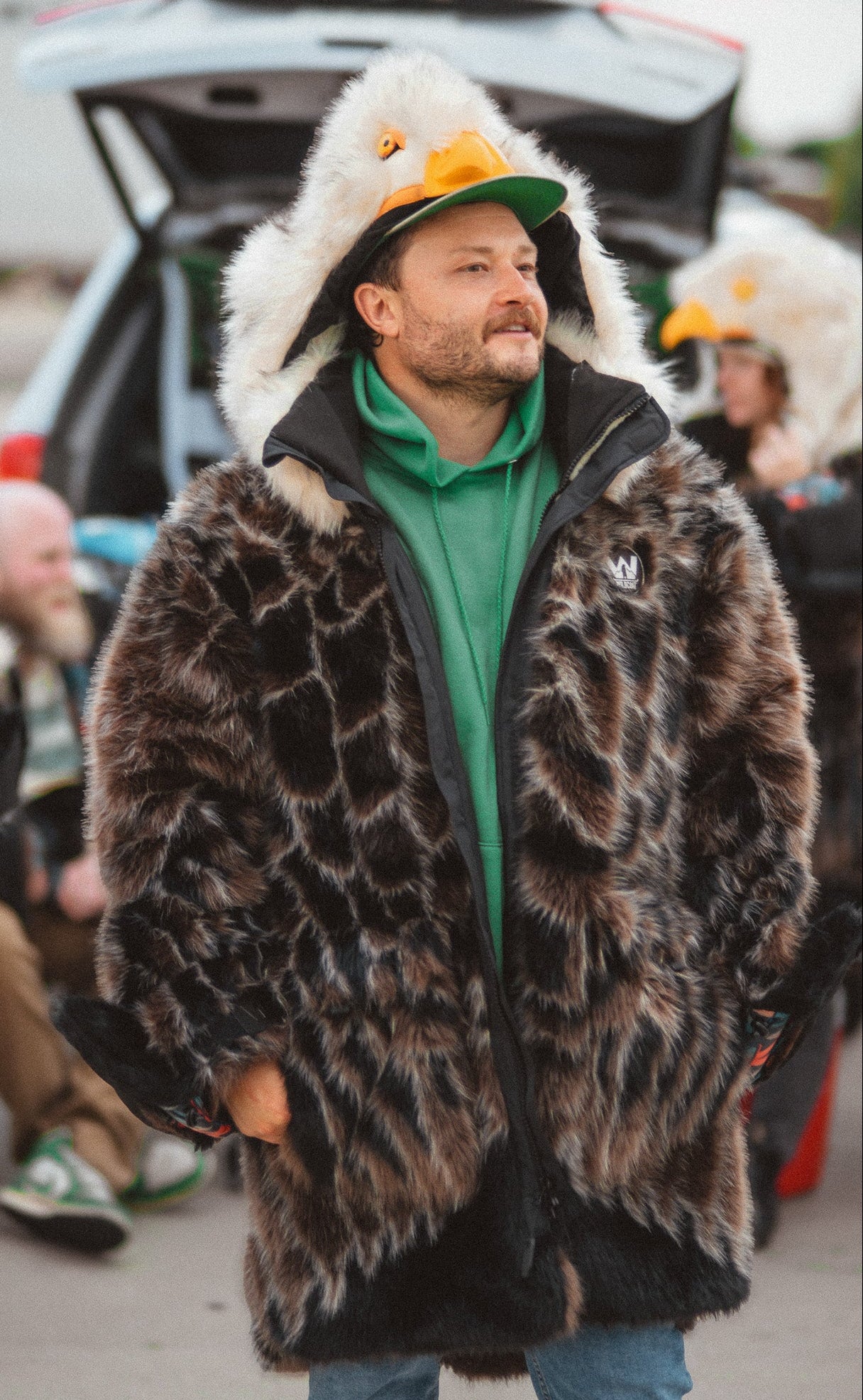 A man wearing the wildcoat v6 eagle parka coat at a philadelphia eagles tailgate.