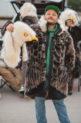 a man wearing a wildcoat eagle v6 parka coat with the hood detached, celebrating at a philadelphia eagles tailgate