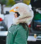 Woman wearing an eagle hood at a philadelphia eagles tailgate while wearing a kelly green eagles jacket