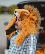 A detroit lions fan wearing a wildoat v6 lion hood over a blue striped track suit at a tailgate