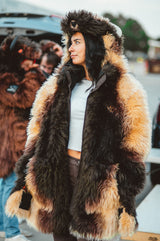 A woman wearing a plush, faux fur great white buffalo winter coat parka at a buffalo bills tailgate