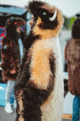 A woman wearing a plush, faux fur great white buffalo winter coat parka at a buffalo bills tailgate