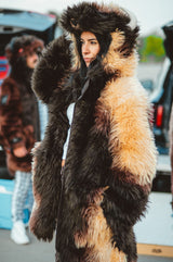 A woman wearing a plush, faux fur great white buffalo winter coat parka at a buffalo bills tailgate