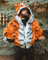 Man wearing new v6 wildcoat orange tiger bomber with the hood up, mittens magnetically connected to the wrists, and orange tinted sunglasses