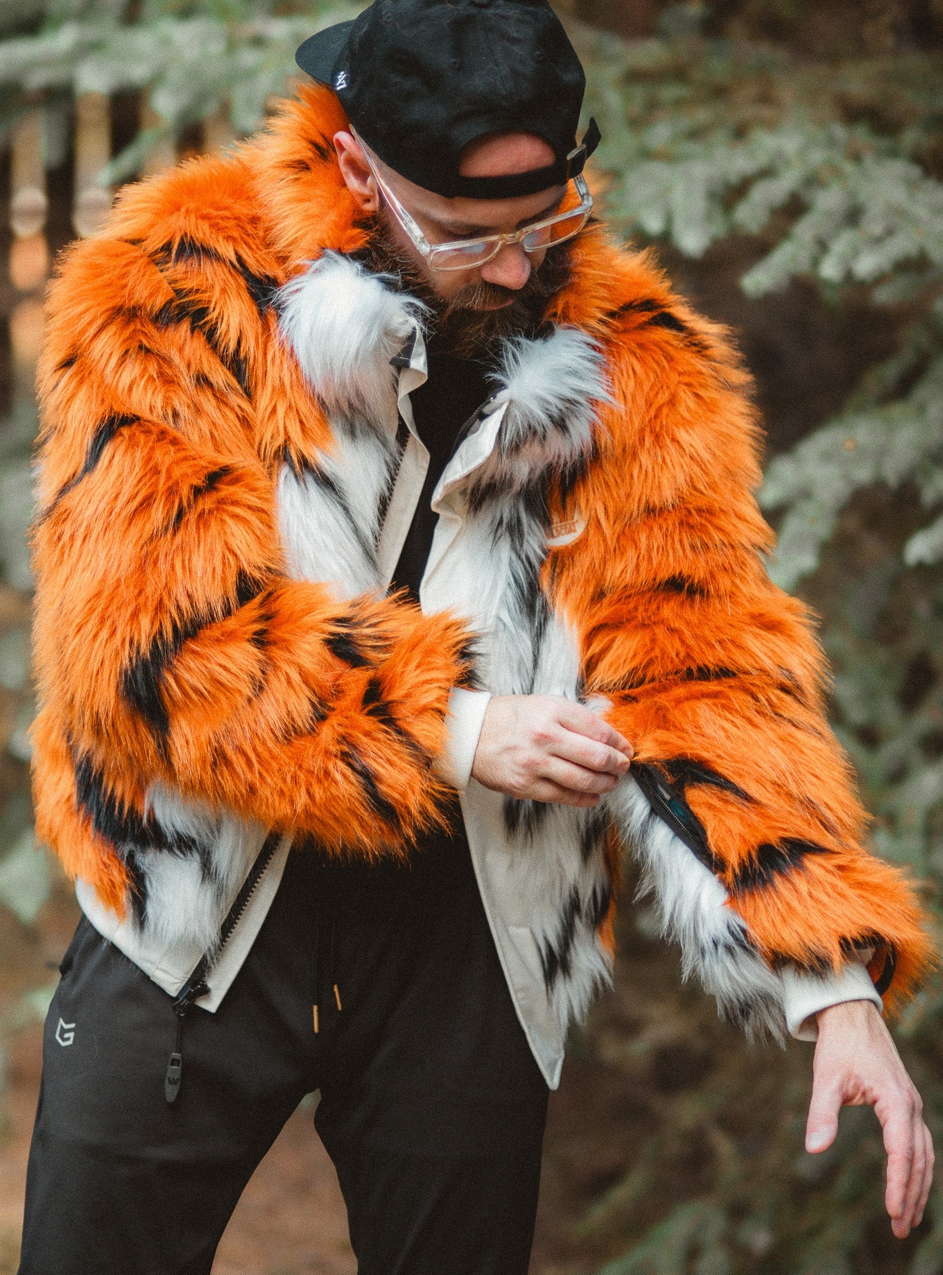 Man wearing the new wildcoat orange tiger bomber jacket coat showing the hidden sleeve zipper on the pass pocket