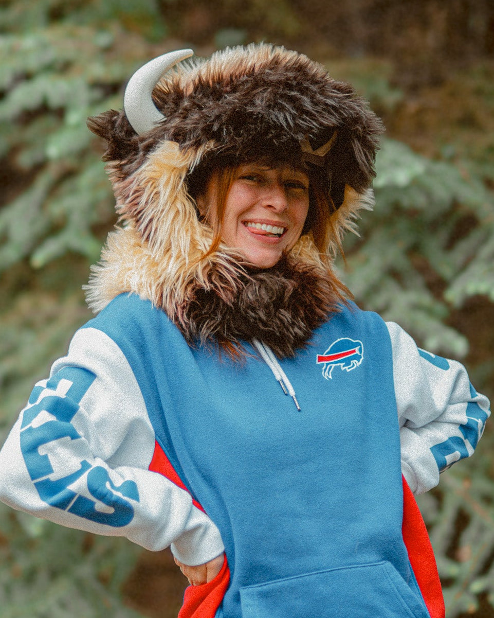 Woman wearing the wildcoat great white buffalo hood and sporting a red white and blue buffalo bills sweatshirt