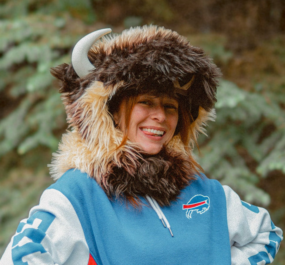 Woman wearing the wildcoat great white buffalo hood and sporting a red white and blue buffalo bills sweatshirt