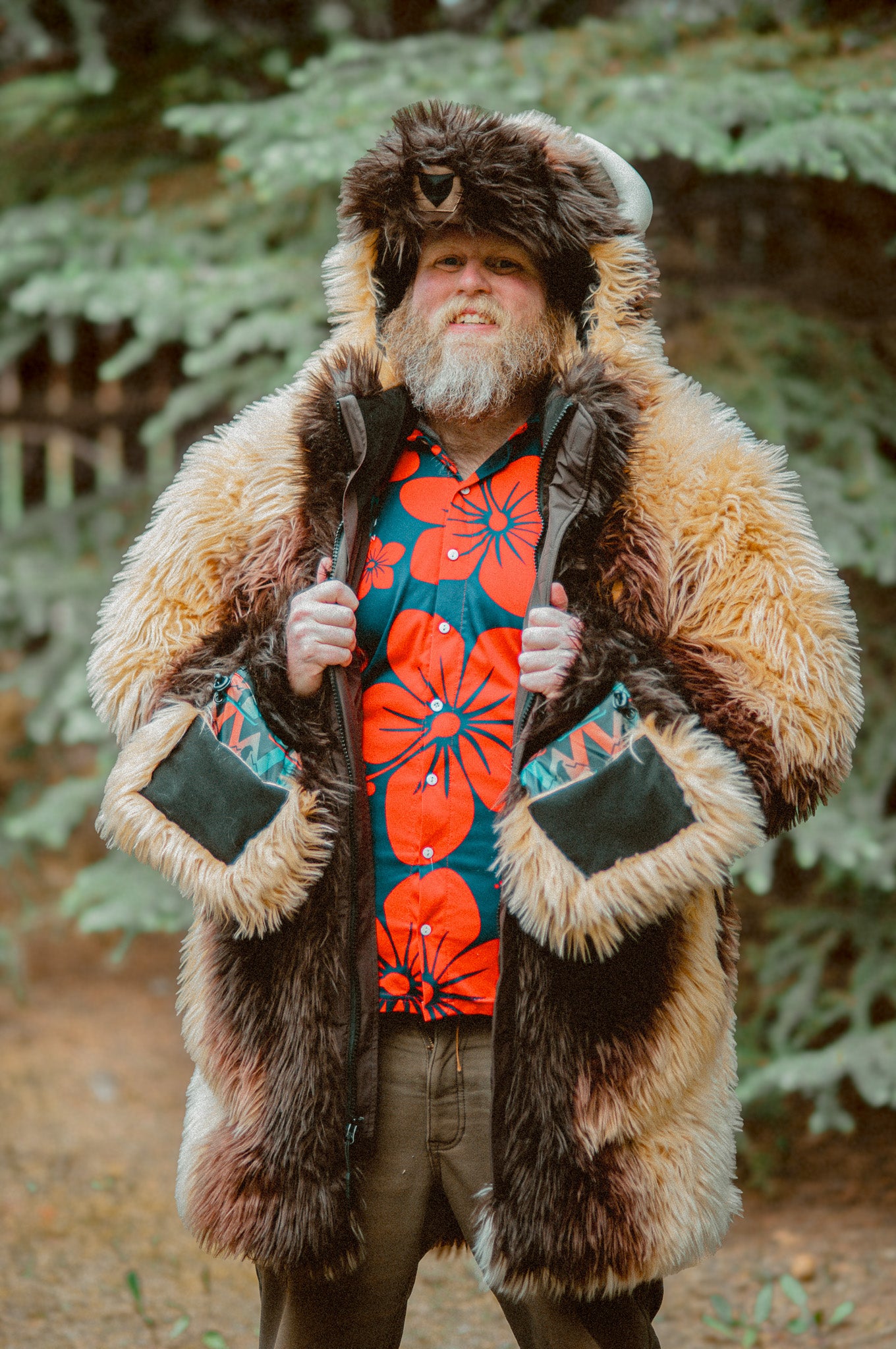 A man with a beard wearing the wildcoat great white buffalo coat holding the main zip