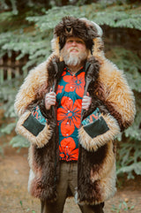 A man with a beard wearing the wildcoat great white buffalo coat holding the main zip