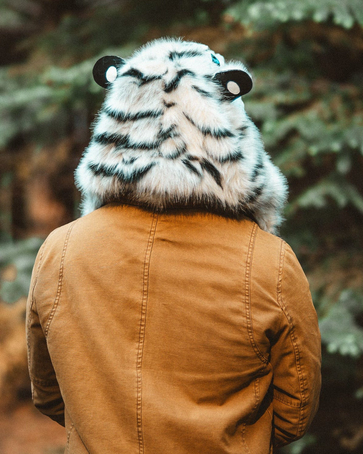 man wearing the wildcoat white tiger hood  showing the back of the hood