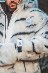 a close up picture of the wildcoat white tiger parka showcasing the chest patch and branded wrist cuffs