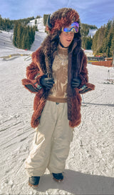 Man wearing a buffalo bison faux fur coat at a ski resort