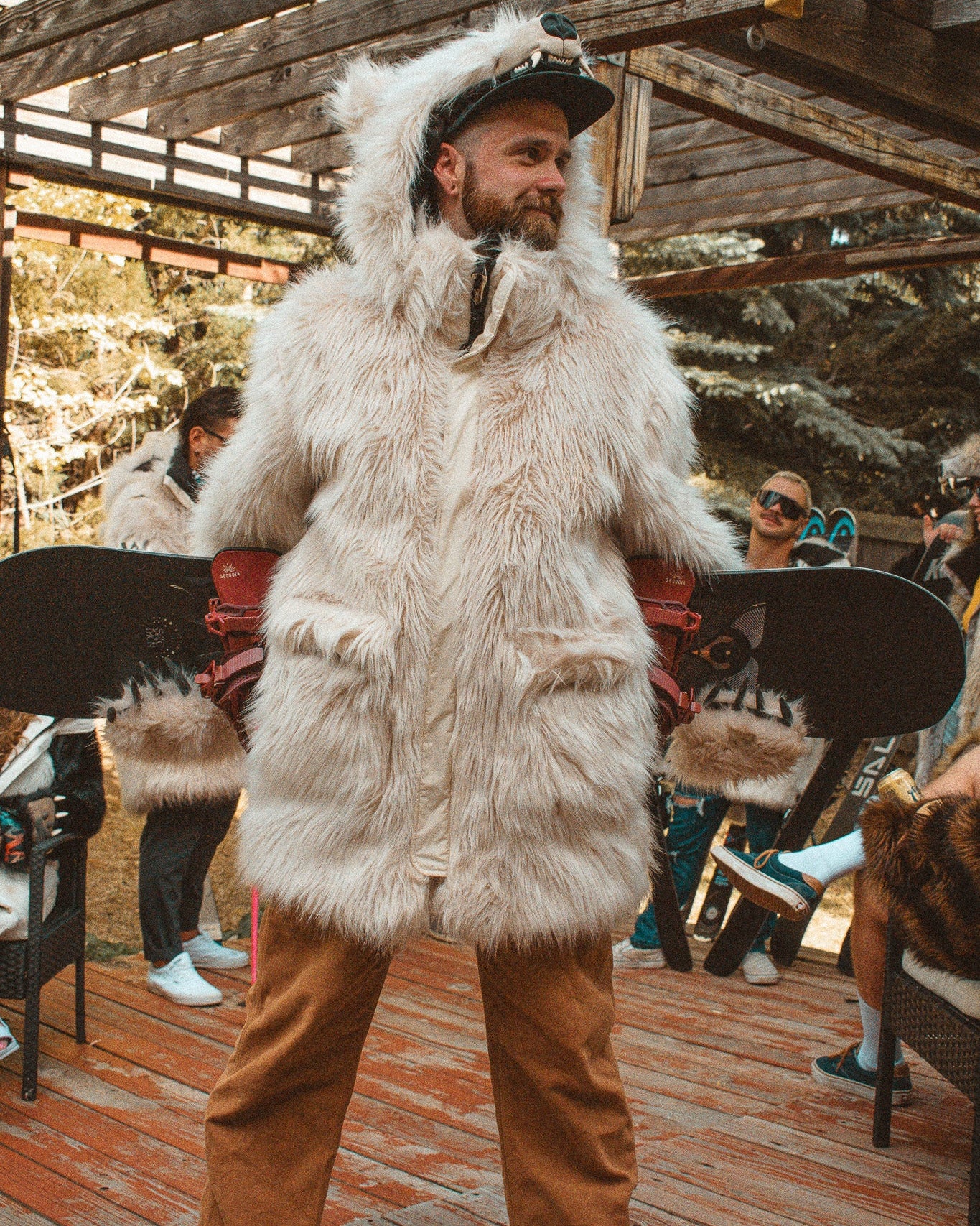 the wildcoat polar bear parka v6, shown on robbie holding a snowboard