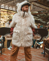 the wildcoat polar bear parka v6, shown on robbie holding a snowboard